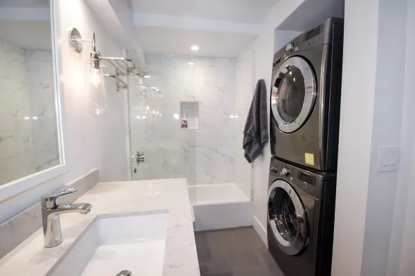 a view of a bathroom with washing machine and dryer