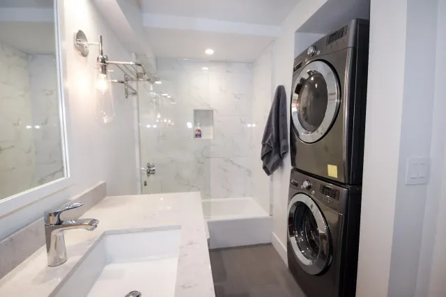 a view of a bathroom with washing machine and dryer