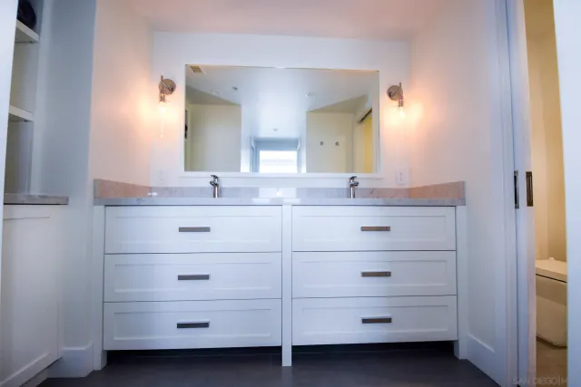 a bathroom with a double vanity sink and mirror