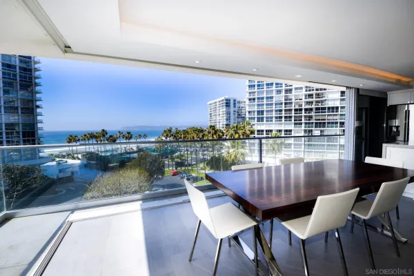 a view of a chairs and table in the balcony