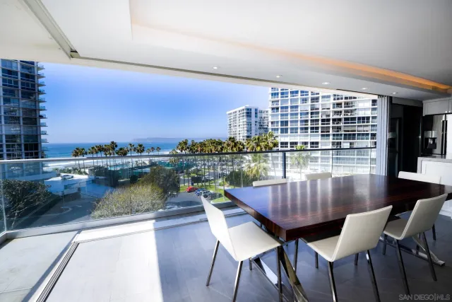 a view of a chairs and table in the balcony