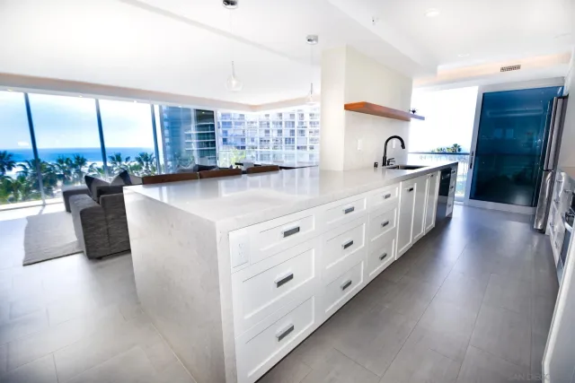 a kitchen with counter top space and wooden floor
