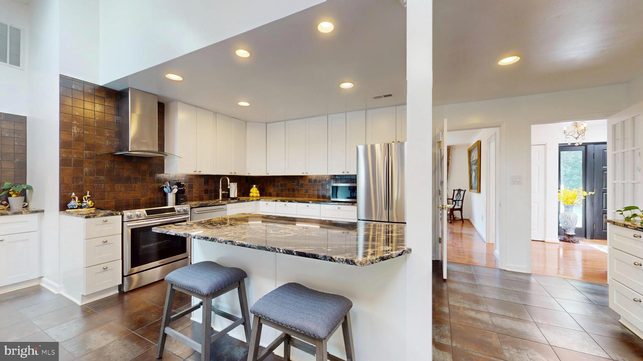 317 Springvale Road Great Falls, VA 22066 - Photo 12 of 98 a kitchen with stainless steel appliances granite countertop a stove a sink and a refrigerator