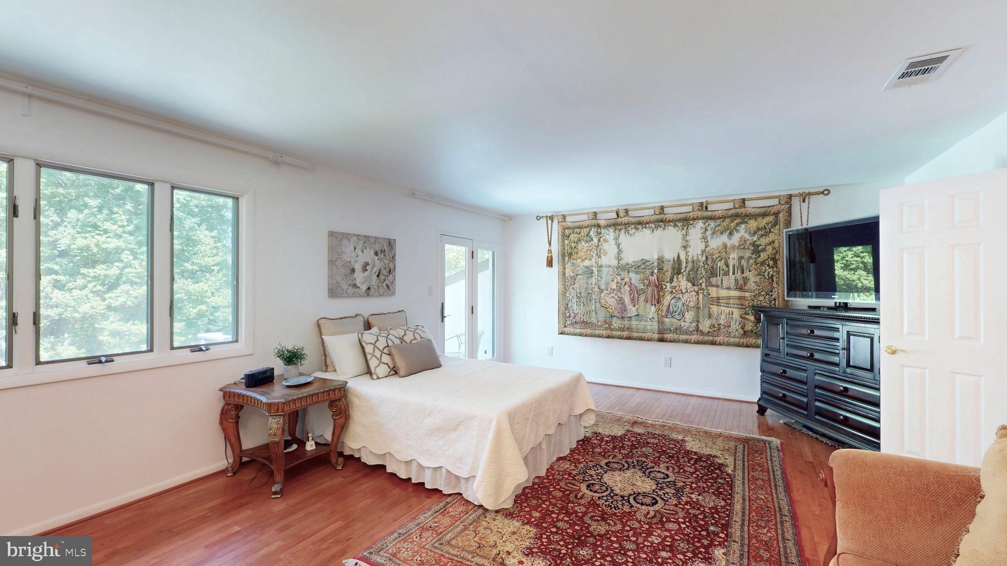 317 Springvale Road Great Falls, VA 22066 - Photo 29 of 98 a spacious bedroom with a bed and a window