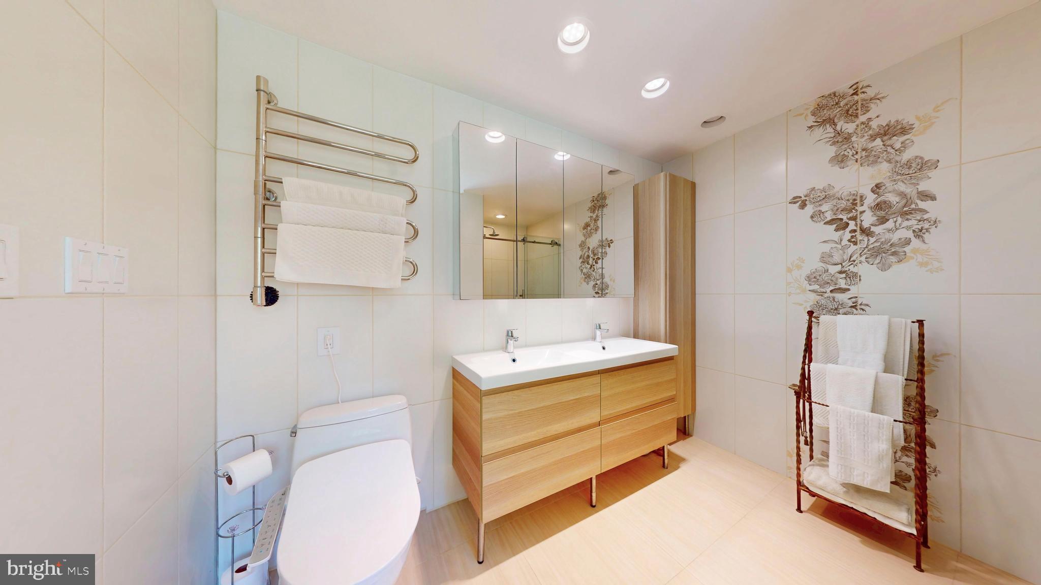 317 Springvale Road Great Falls, VA 22066 - Photo 31 of 98 a bathroom with a sink toilet double vanity and shower