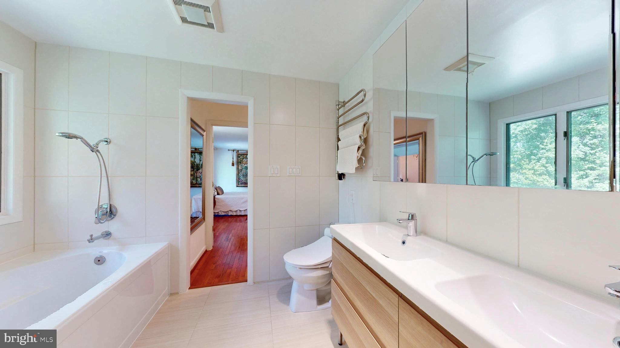 317 Springvale Road Great Falls, VA 22066 - Photo 33 of 98 a bathroom with a bathtub a sink a toilet and a shower