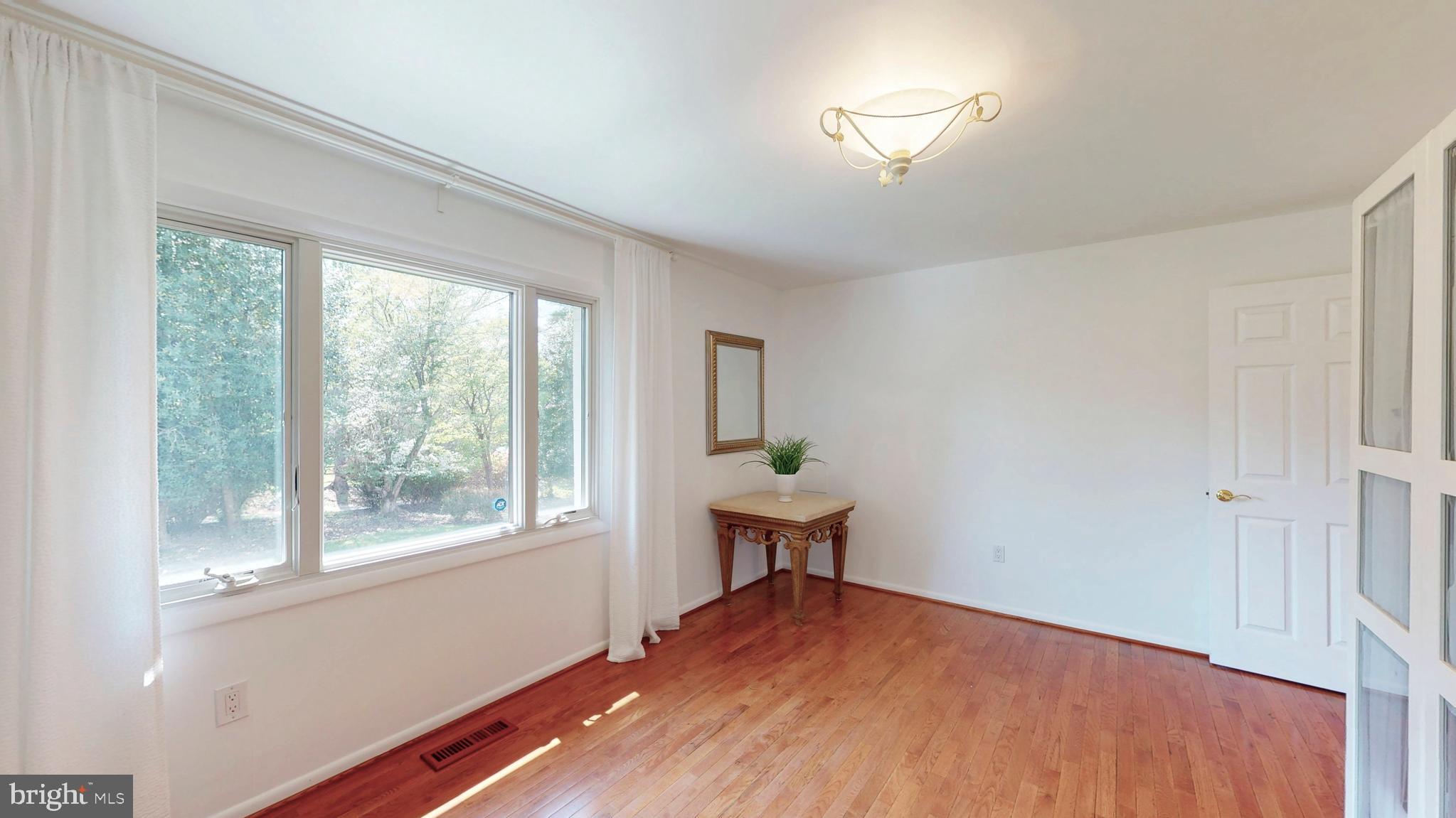 317 Springvale Road Great Falls, VA 22066 - Photo 38 of 98 a view of empty room with wooden floor and fan