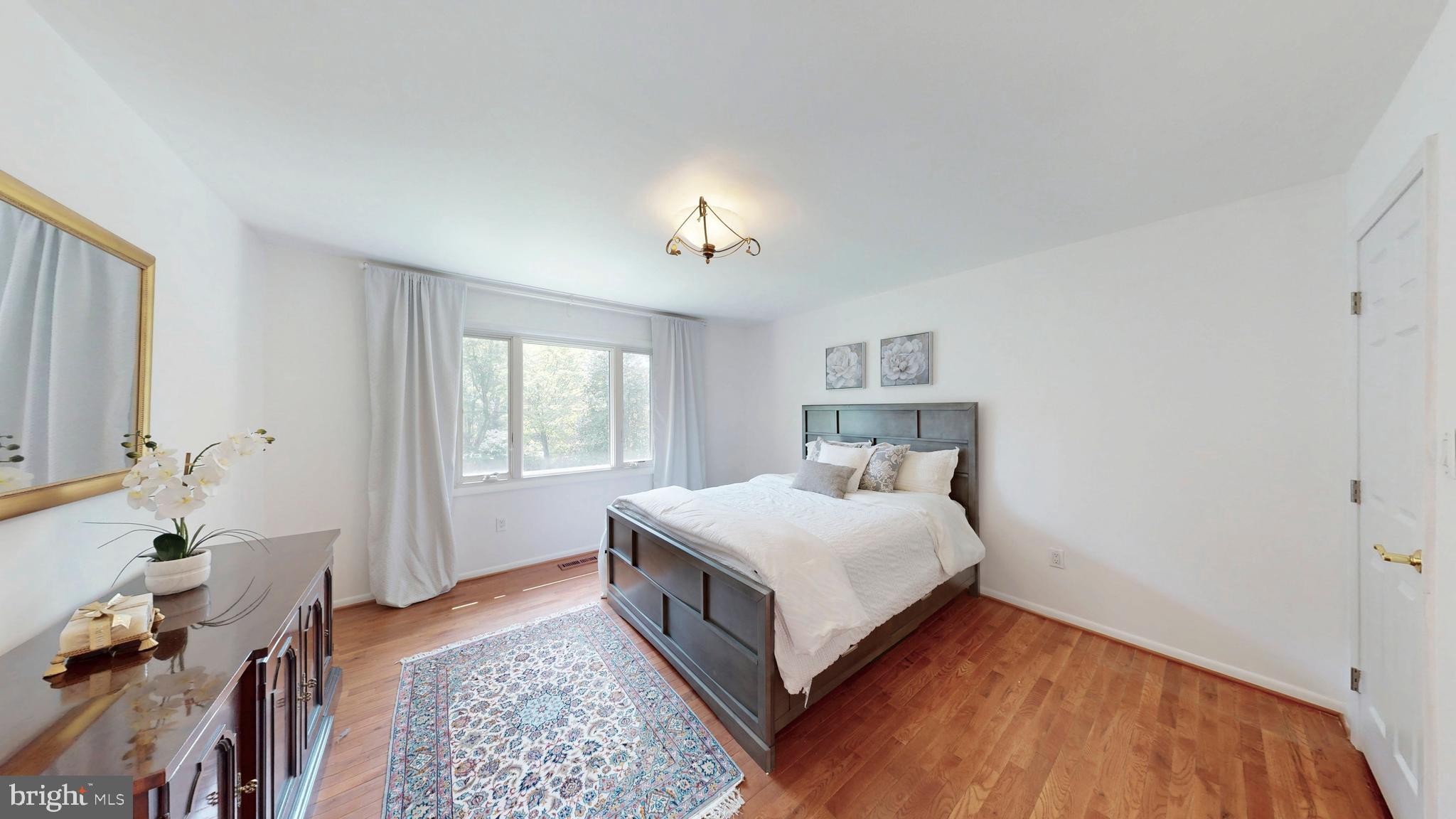 317 Springvale Road Great Falls, VA 22066 - Photo 42 of 98 a bedroom with a bed and wooden floor