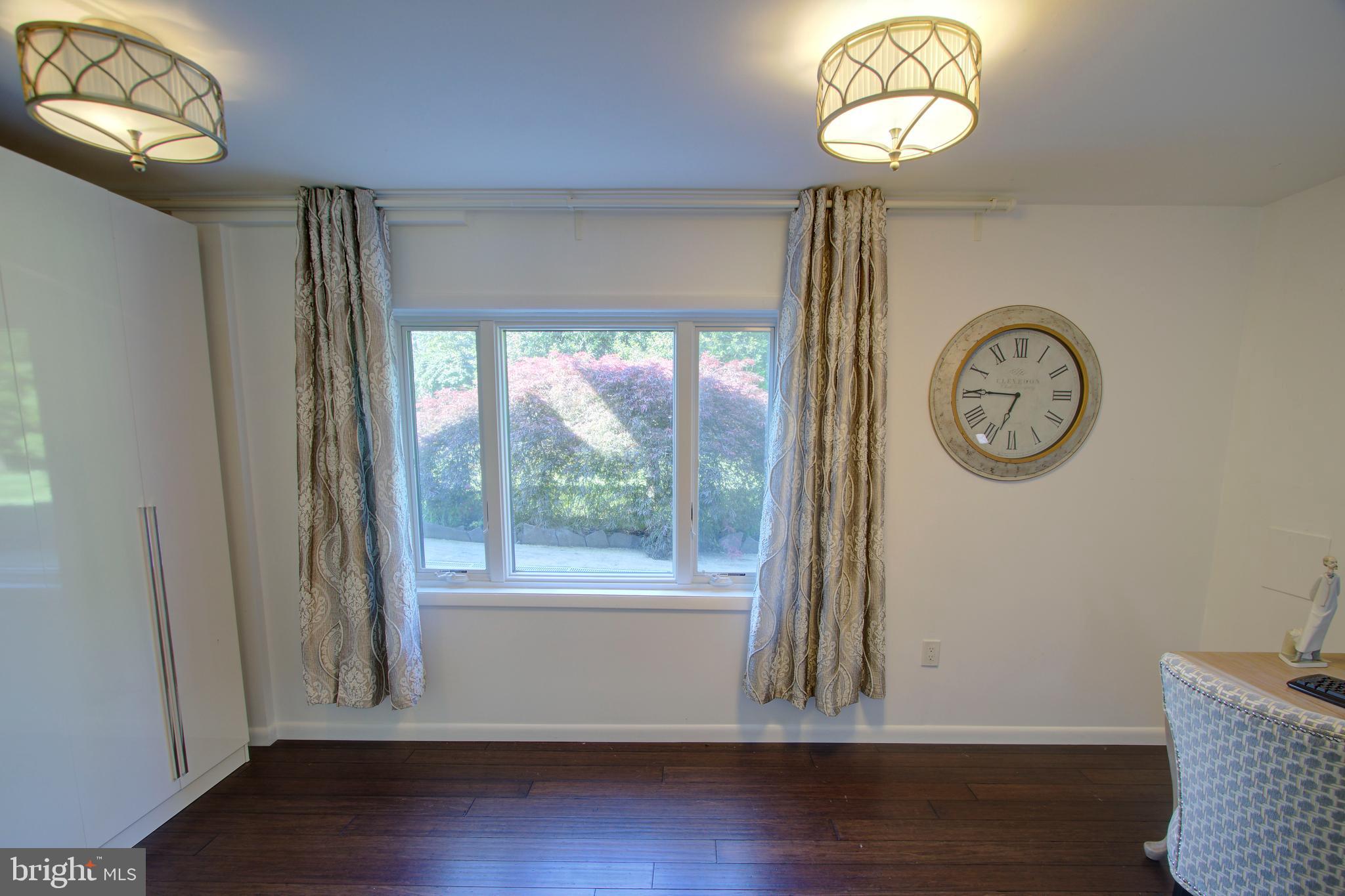 317 Springvale Road Great Falls, VA 22066 - Photo 47 of 98 a view of a hallway with a large window and wooden floor