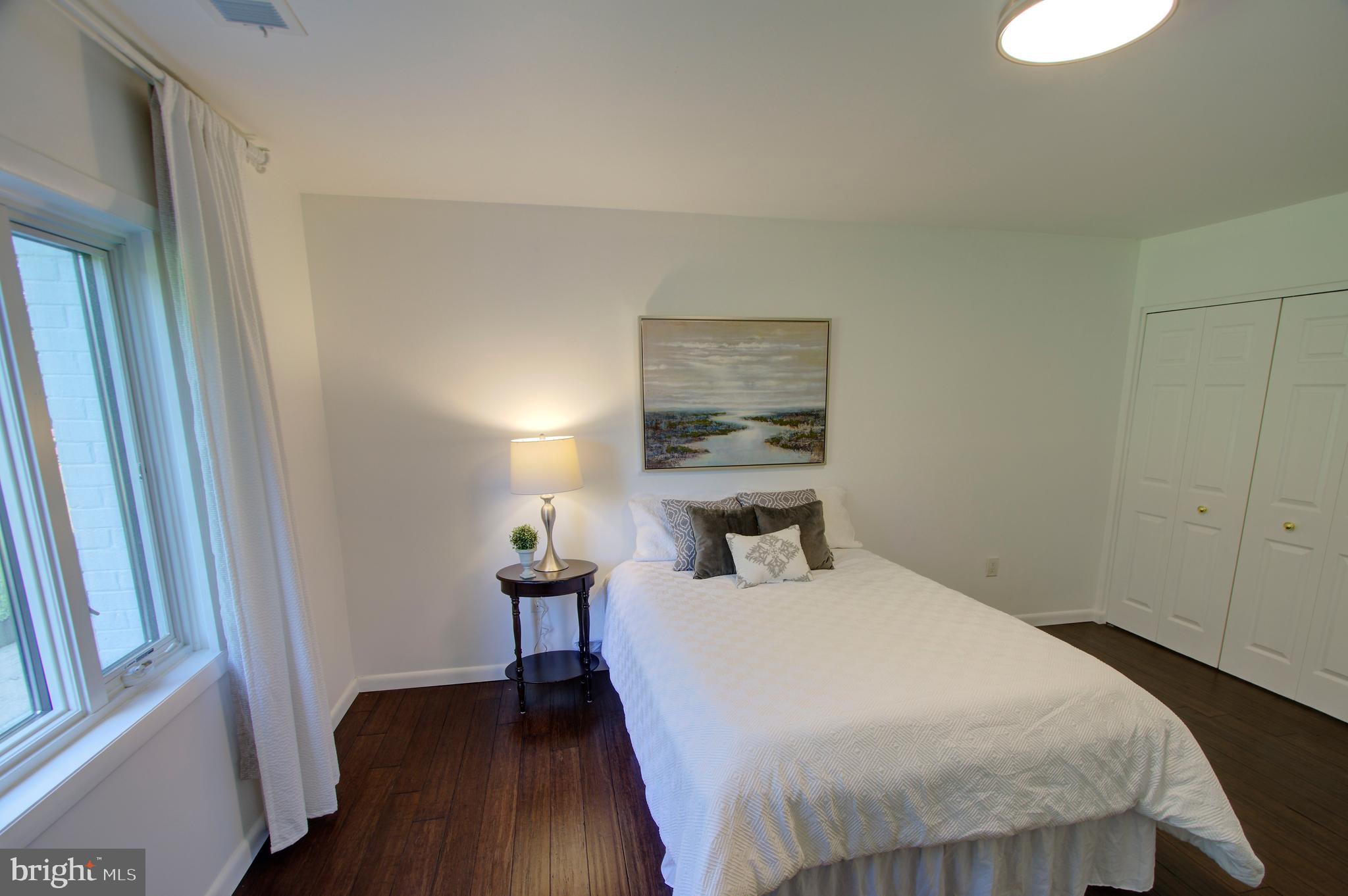 317 Springvale Road Great Falls, VA 22066 - Photo 55 of 98 a bedroom with a bed and wooden floor