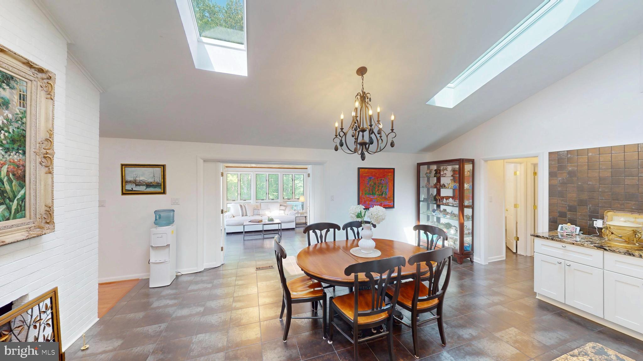 317 Springvale Road Great Falls, VA 22066 - Photo 7 of 98 a view of a dining room with furniture a chandelier and window