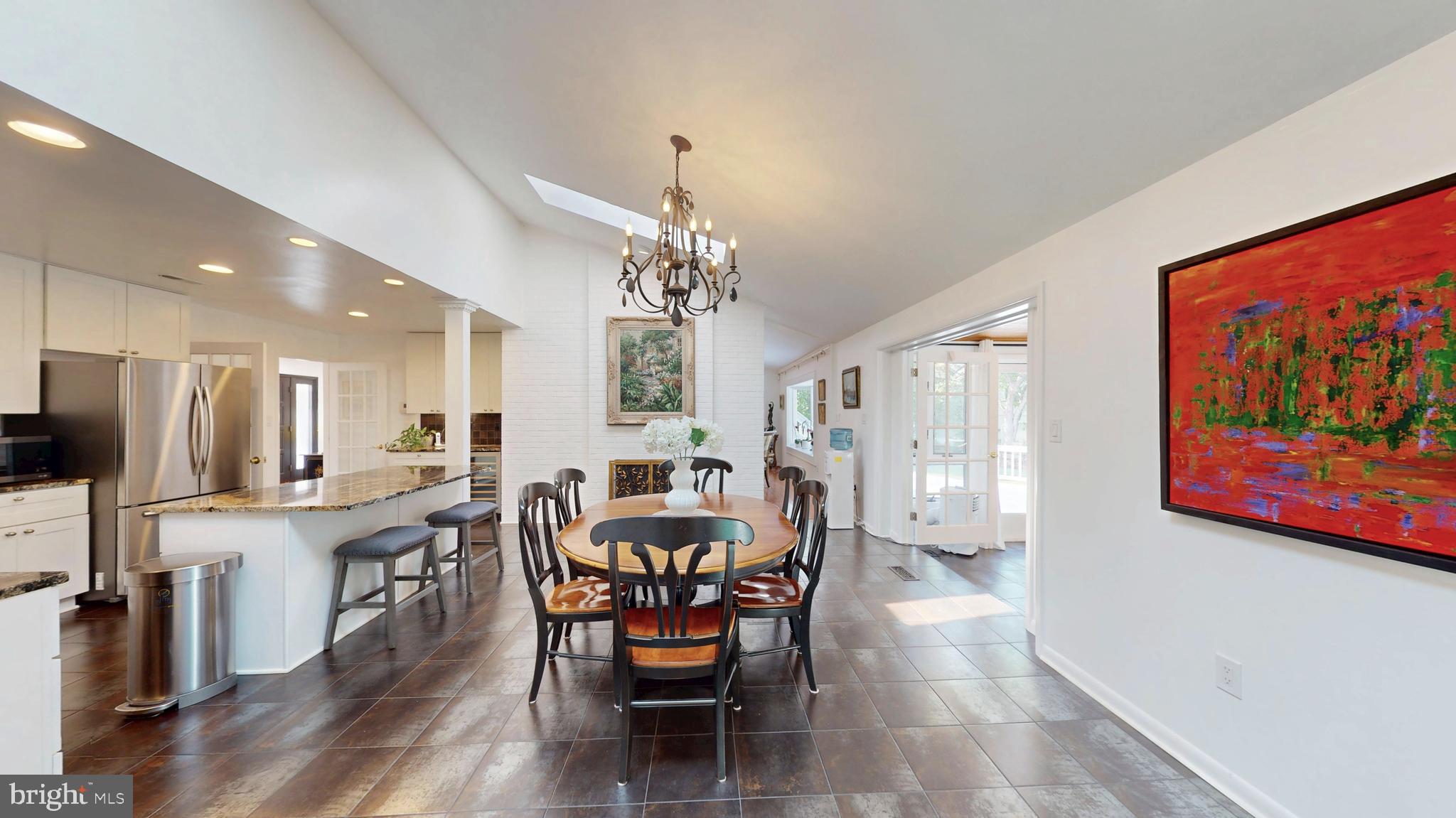 317 Springvale Road Great Falls, VA 22066 - Photo 8 of 98 a view of a dining room with furniture a chandelier and wooden floor
