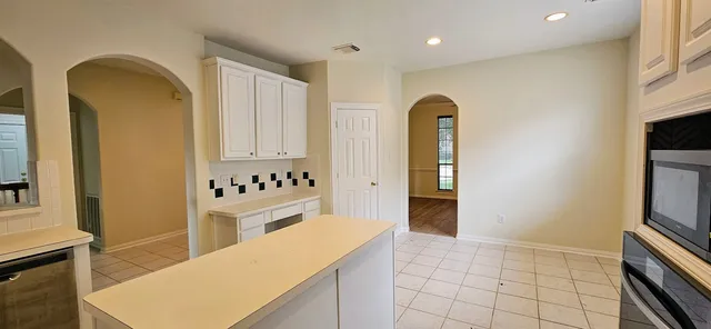 a kitchen that has a sink and a stove in it