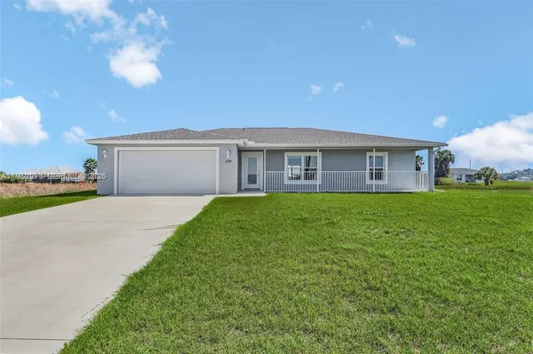 a front view of house with a garden