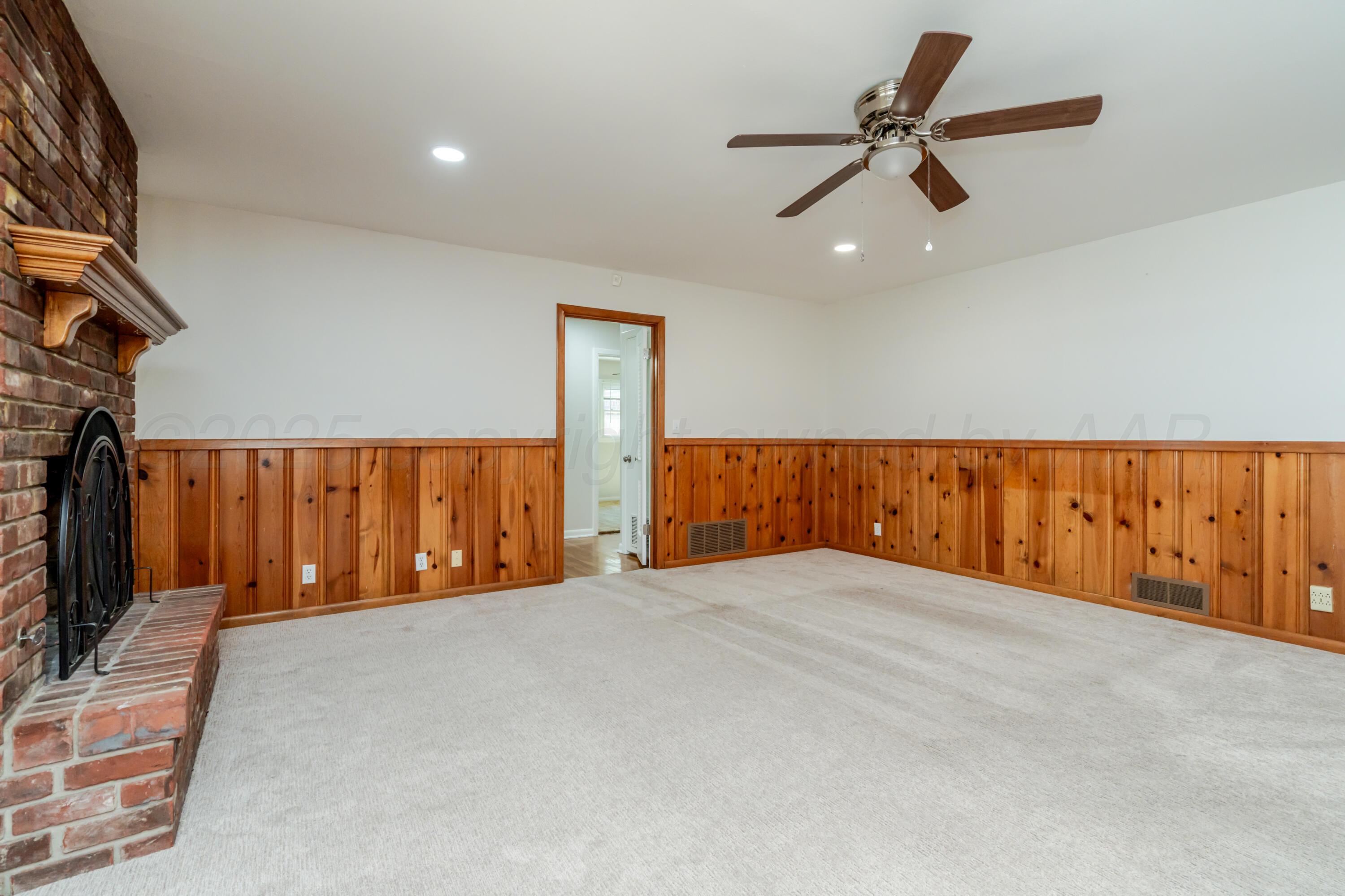 4721 Cherokee Trail Amarillo, TX 79109 - Photo 11 of 42 a view of an empty room with wooden floor