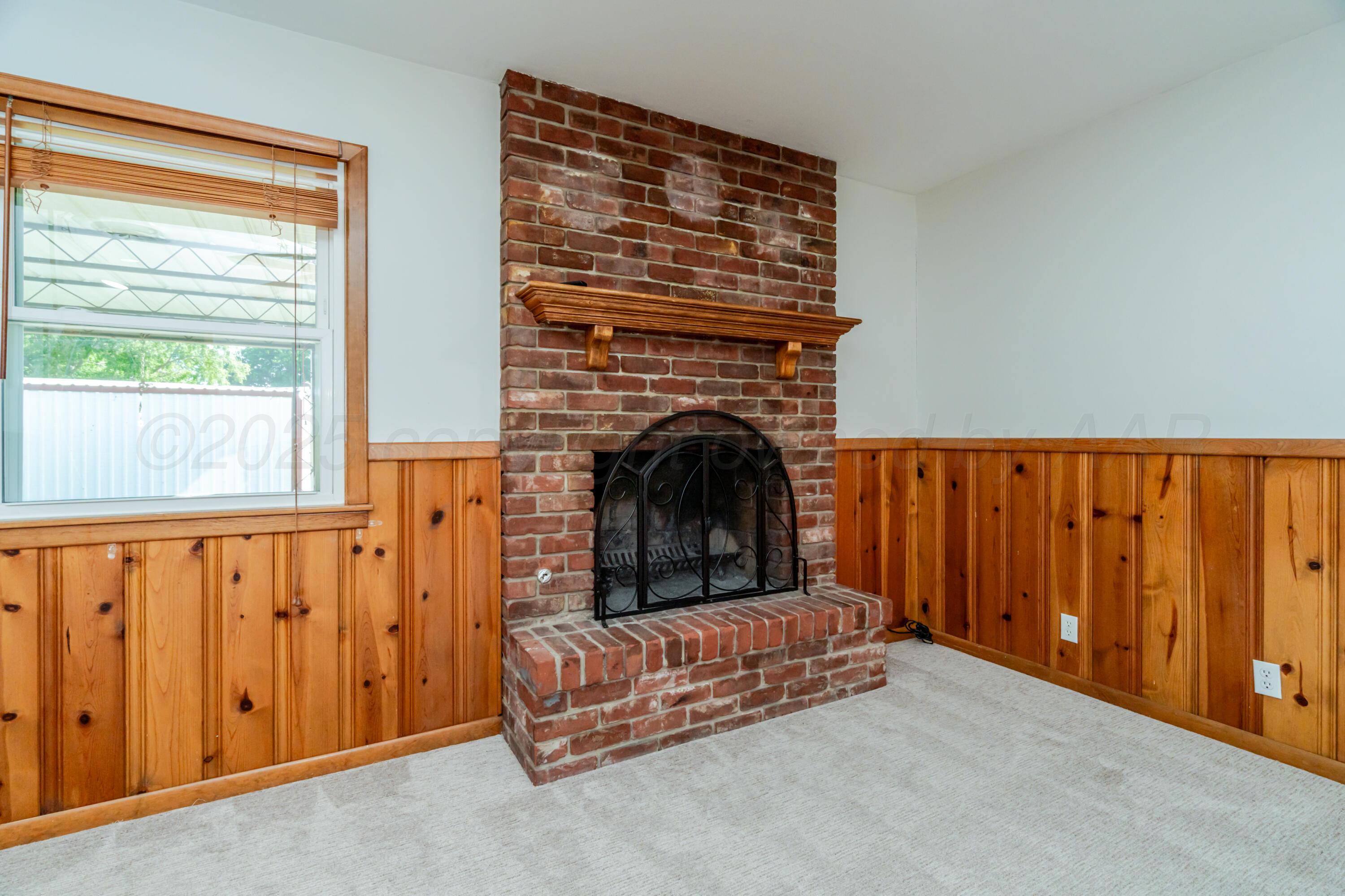 4721 Cherokee Trail Amarillo, TX 79109 - Photo 12 of 42 a living room with furniture and a fireplace