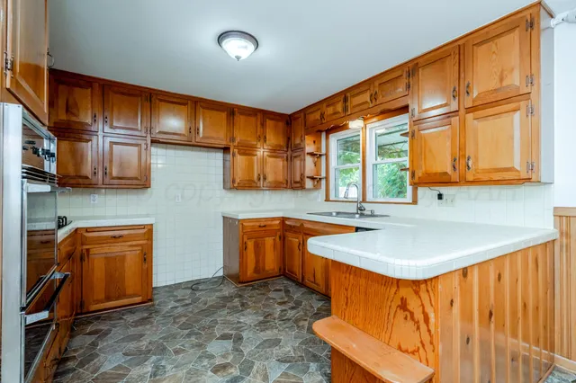 a kitchen with stainless steel appliances granite countertop a stove and a microwave