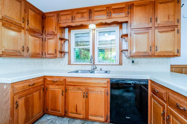 a kitchen with stainless steel appliances granite countertop a sink and a stove