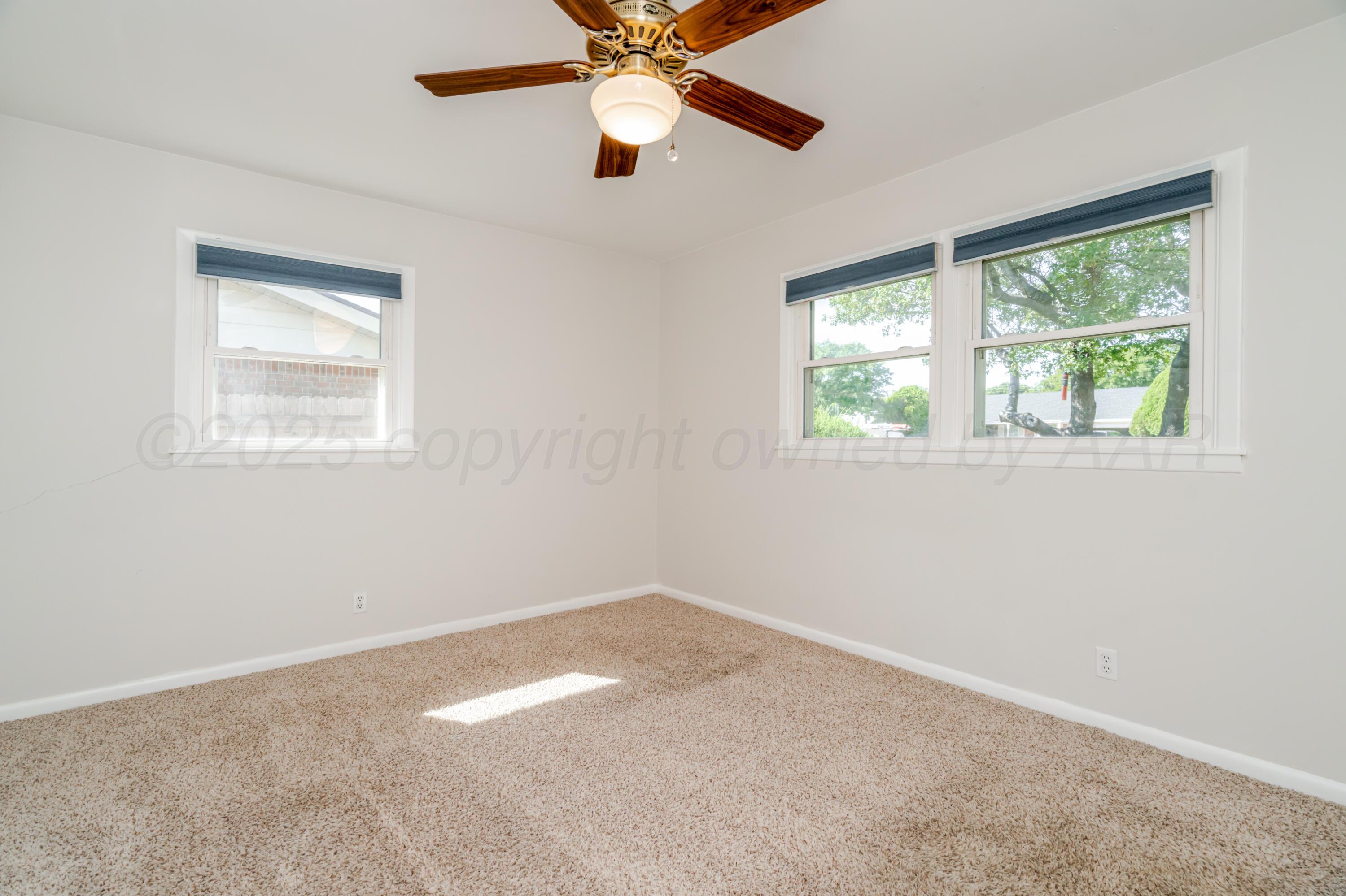 4721 Cherokee Trail Amarillo, TX 79109 - Photo 24 of 42 an empty room with a window and a fan
