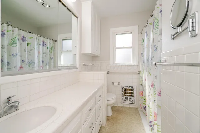 an empty room with fan and windows