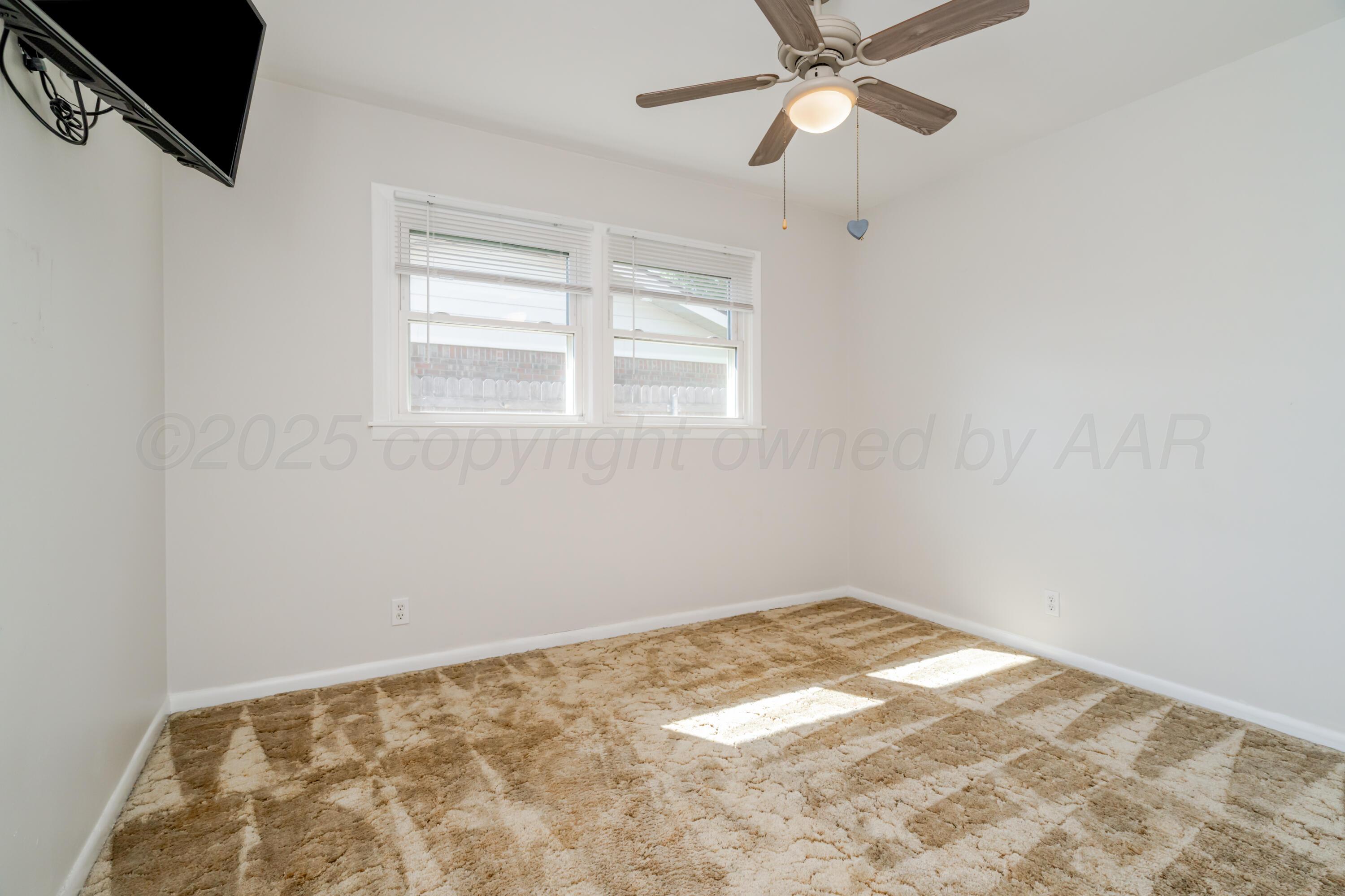4721 Cherokee Trail Amarillo, TX 79109 - Photo 28 of 42 a view of an empty room with a window