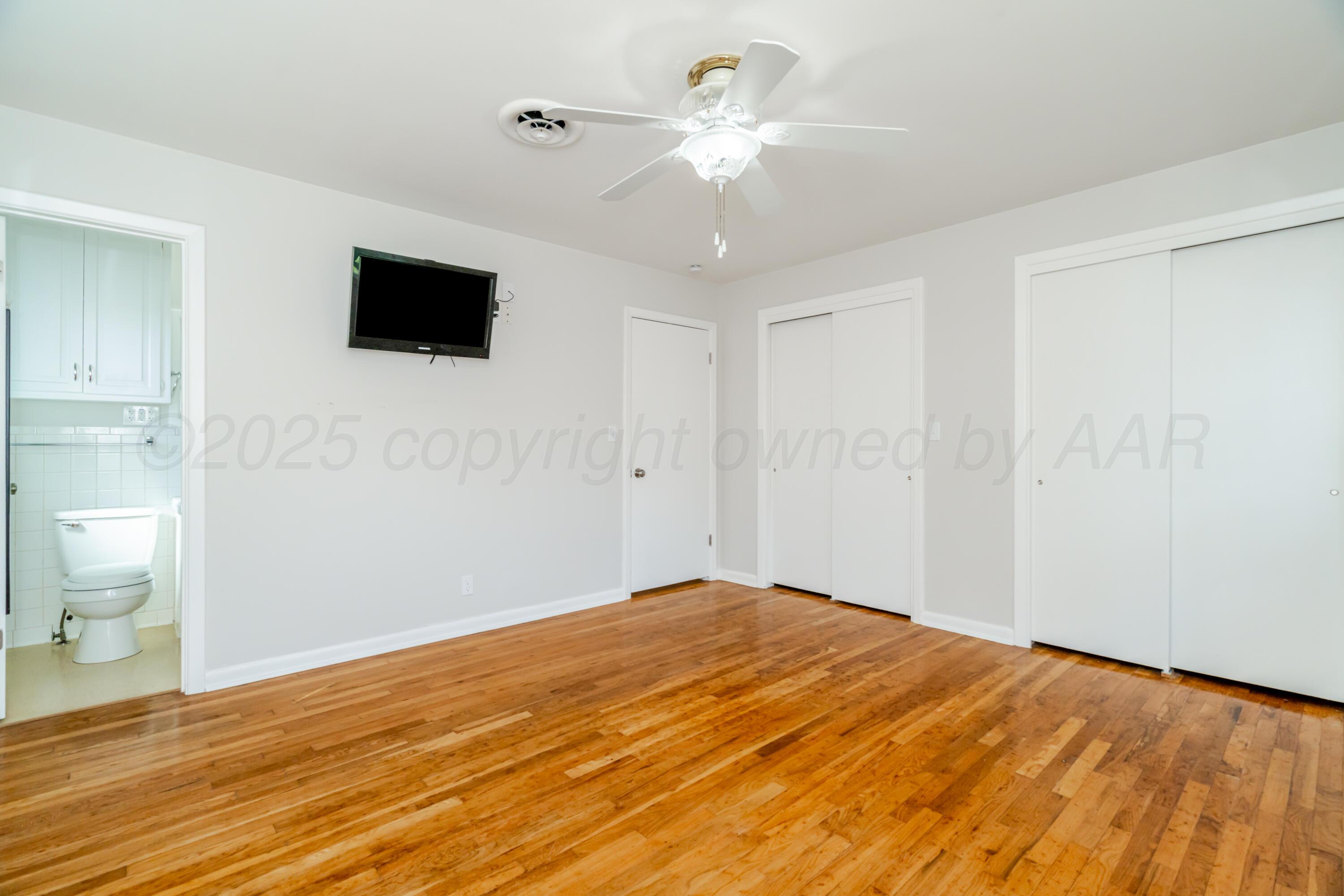 4721 Cherokee Trail Amarillo, TX 79109 - Photo 32 of 42 a view of empty room with wooden floor and fan