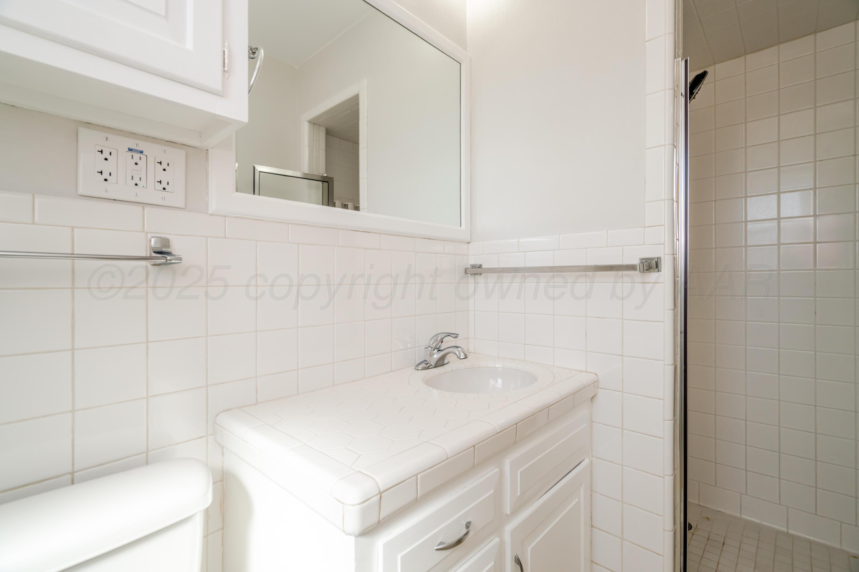 4721 Cherokee Trail Amarillo, TX 79109 - Photo 33 of 42 a bathroom with a sink and vanity