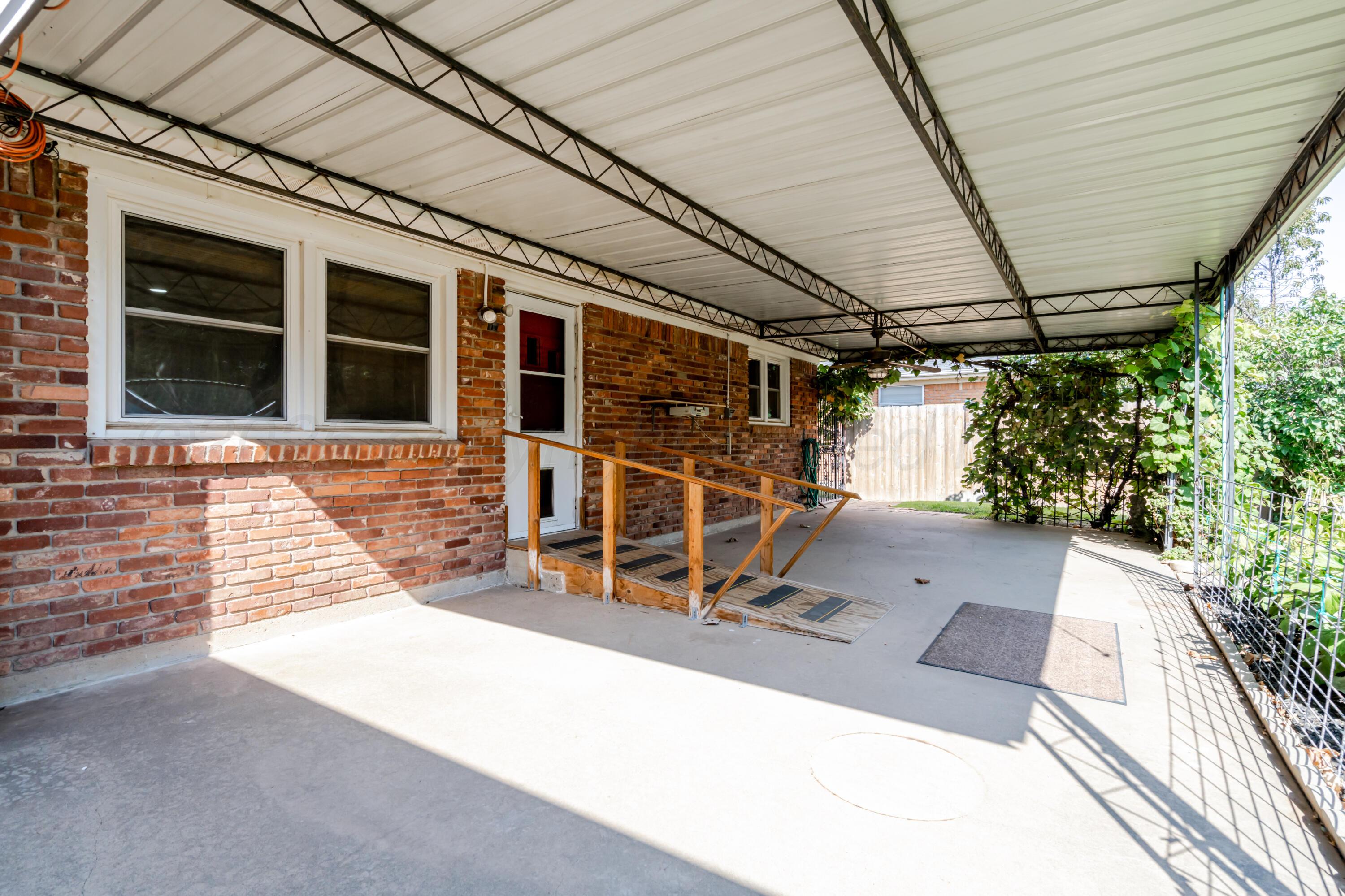 4721 Cherokee Trail Amarillo, TX 79109 - Photo 34 of 42 a view of a porch with wooden floor and iron stairs
