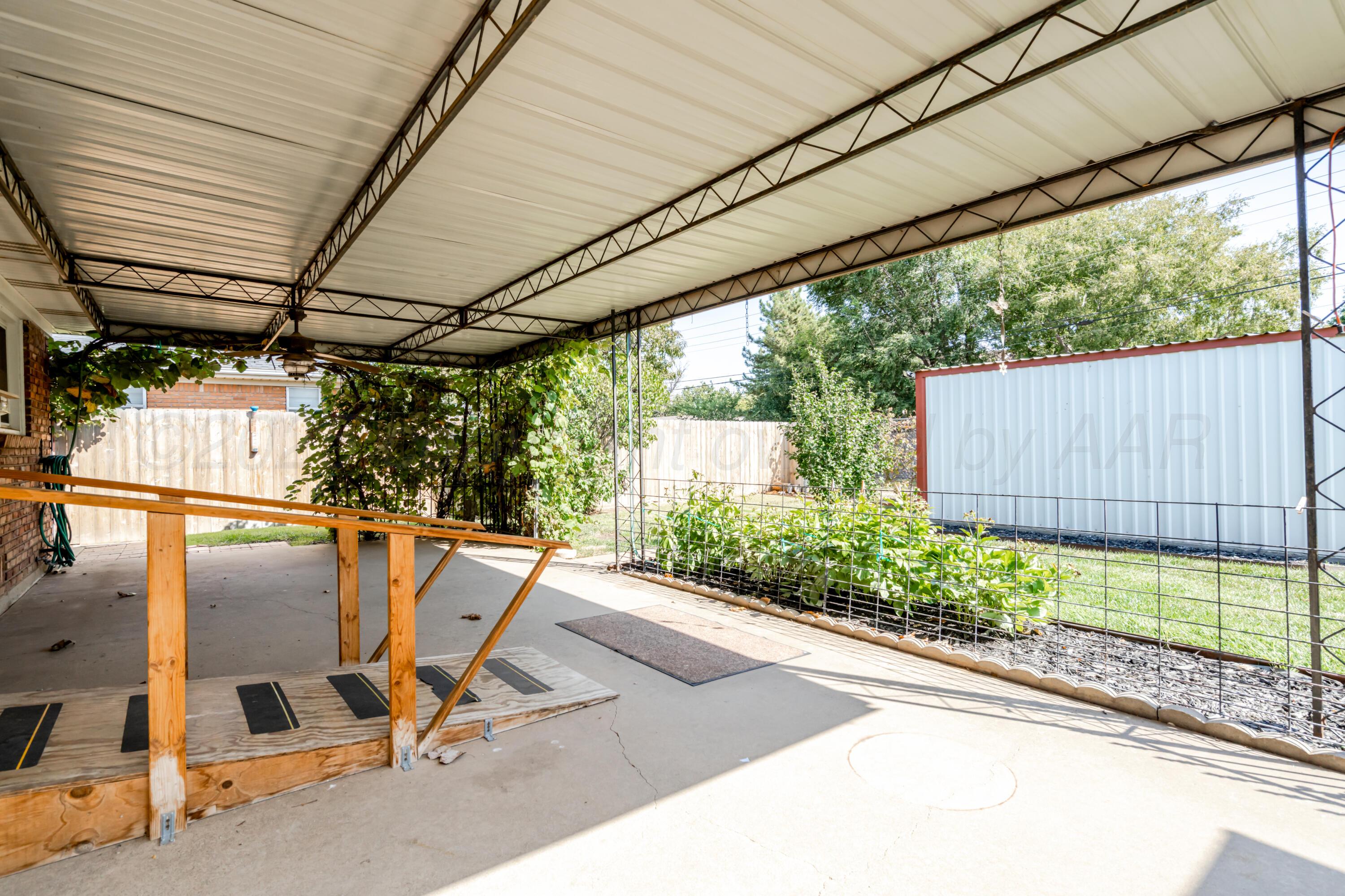 4721 Cherokee Trail Amarillo, TX 79109 - Photo 35 of 42 a view of a patio with table and chairs and floor to ceiling window