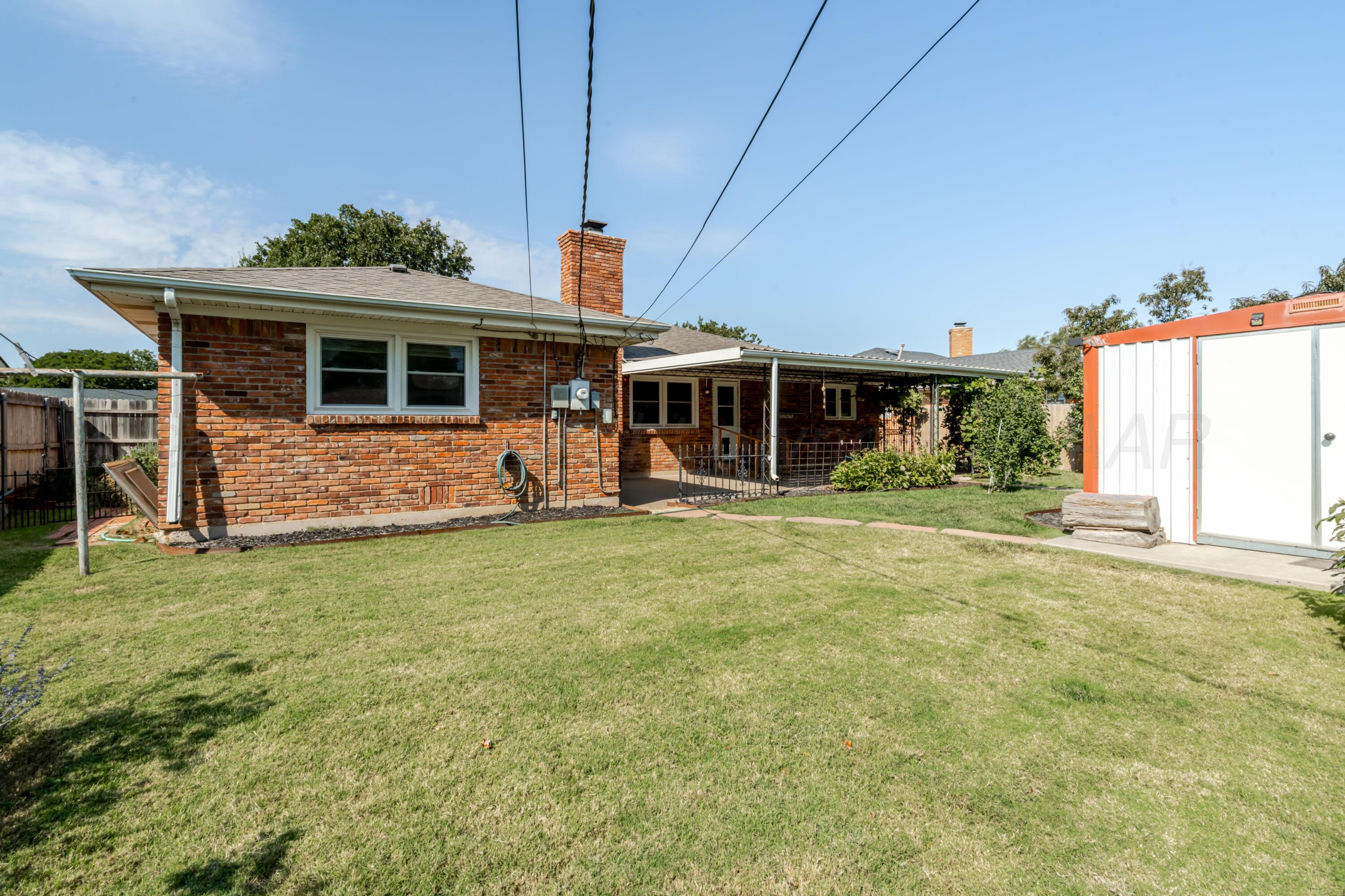4721 Cherokee Trail Amarillo, TX 79109 - Photo 42 of 42 a front view of a house with a yard table and chairs