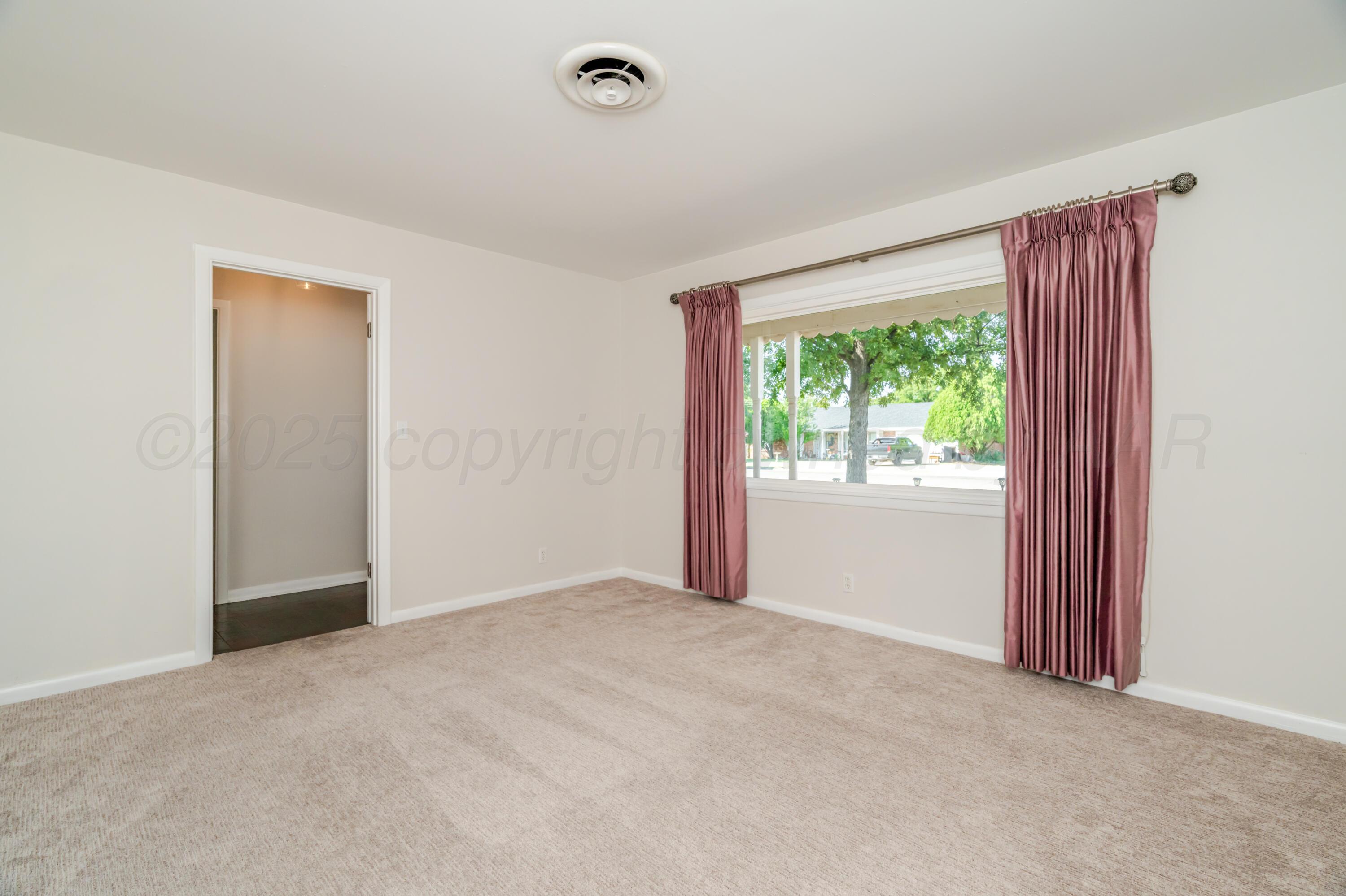 4721 Cherokee Trail Amarillo, TX 79109 - Photo 8 of 42 a view of an empty room with a window