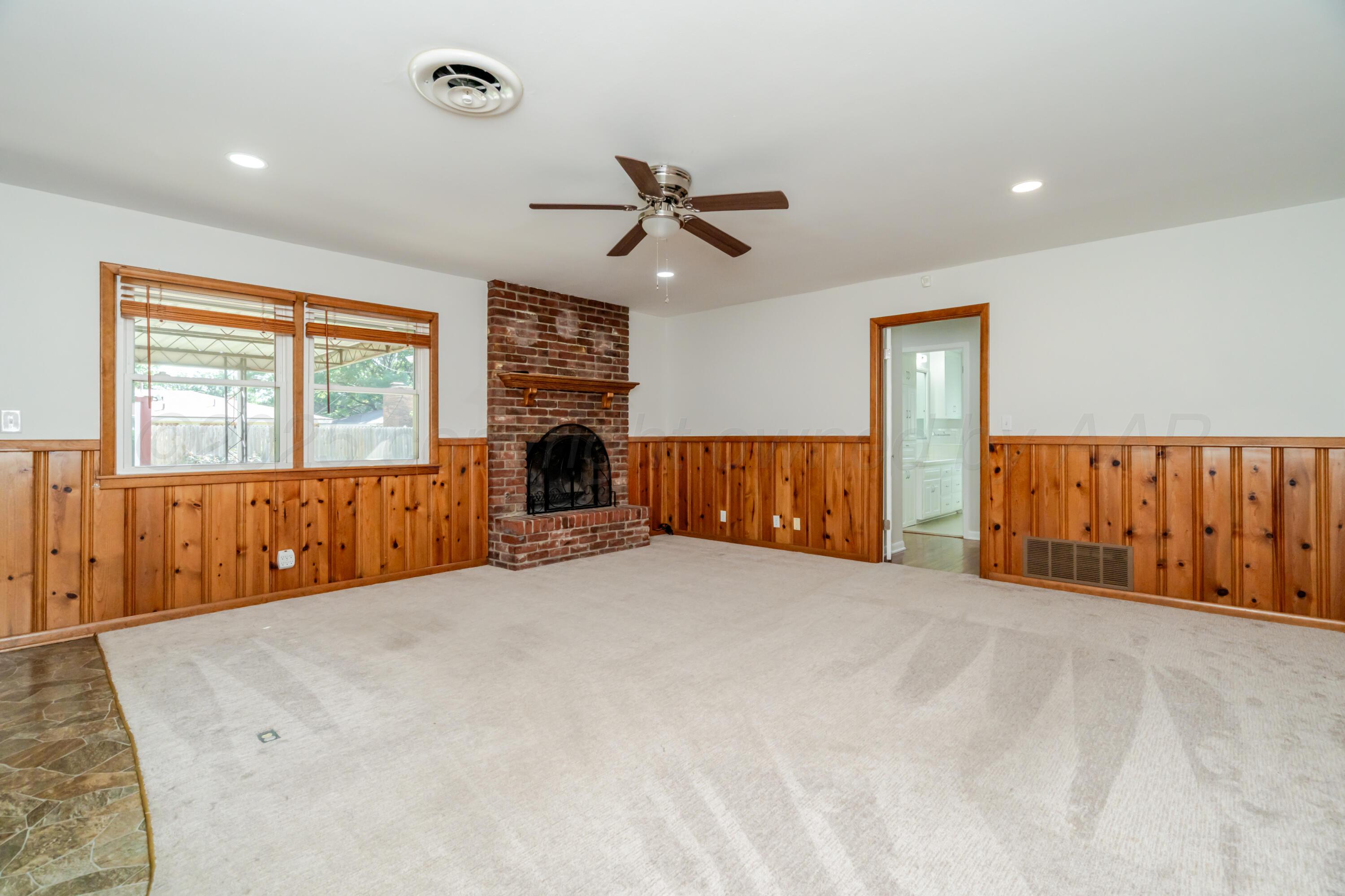 4721 Cherokee Trail Amarillo, TX 79109 - Photo 10 of 42 an empty room with windows and ceiling fan