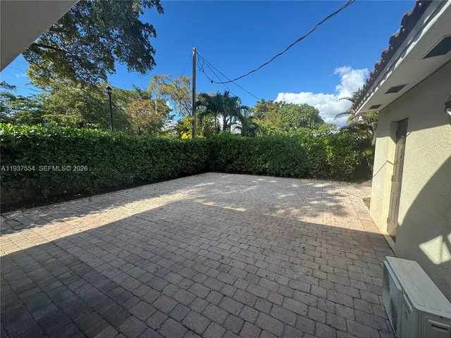a view of a backyard with potted plants