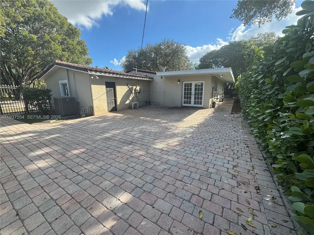 a front view of a house with a yard and a garage