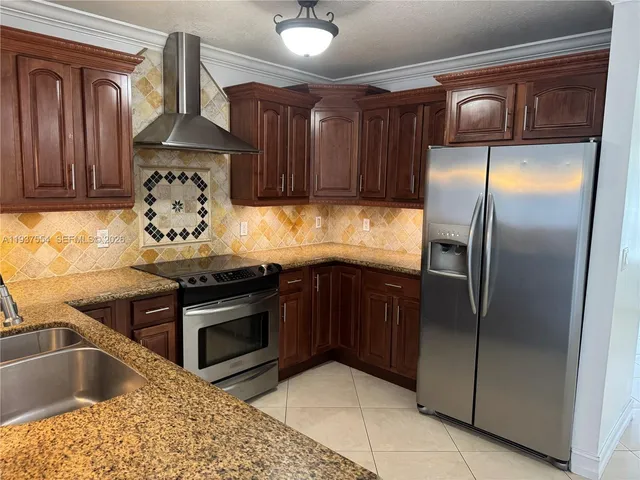a kitchen with a refrigerator sink and cabinets