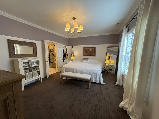 a bedroom with furniture and a chandelier