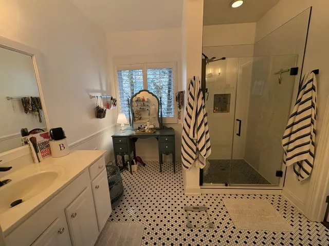 a bathroom with a sink a toilet and a mirror