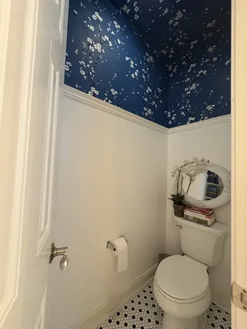 a white toilet sitting next to a shower