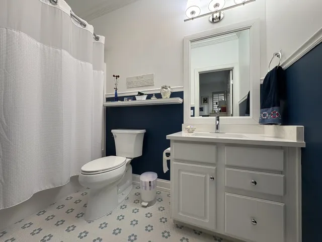 a bathroom with a sink toilet a mirror and shower