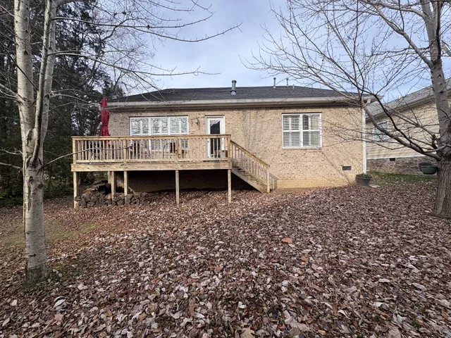 a view of a house with a yard and sitting area