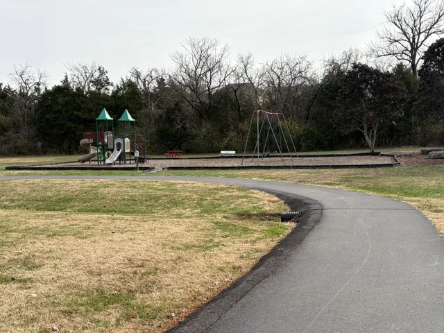 a view of a swimming pool and trees in the background