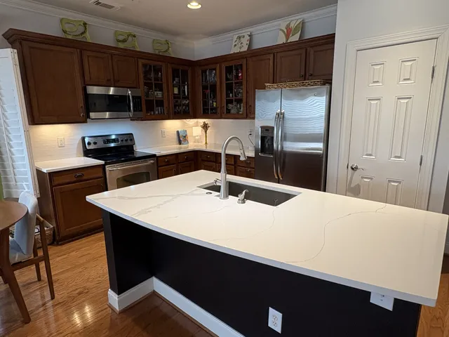 a kitchen with a sink a refrigerator and cabinets