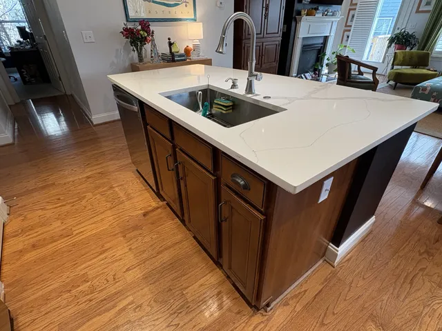 a kitchen with a sink a microwave and cabinets