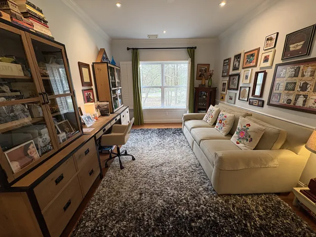 a living room with furniture fireplace and a window
