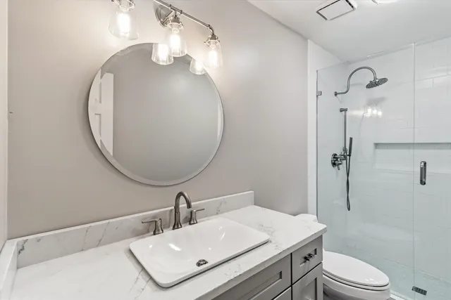 a bathroom with a sink toilet and shower