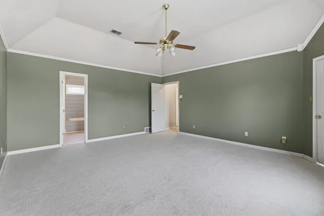 a view of an empty room with a ceiling fan