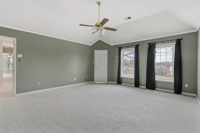 a view of a livingroom with a ceiling fan and window
