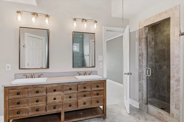 a bathroom with a double vanity sink mirror and double