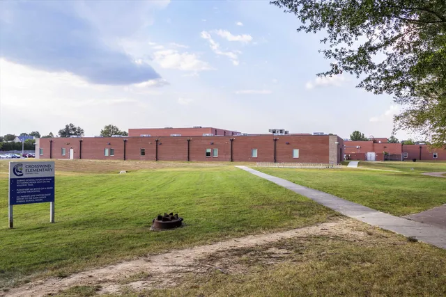an aerial view of residential house with an outdoor space and swimming pool