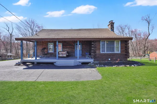 a view of a house with a yard porch and sitting area